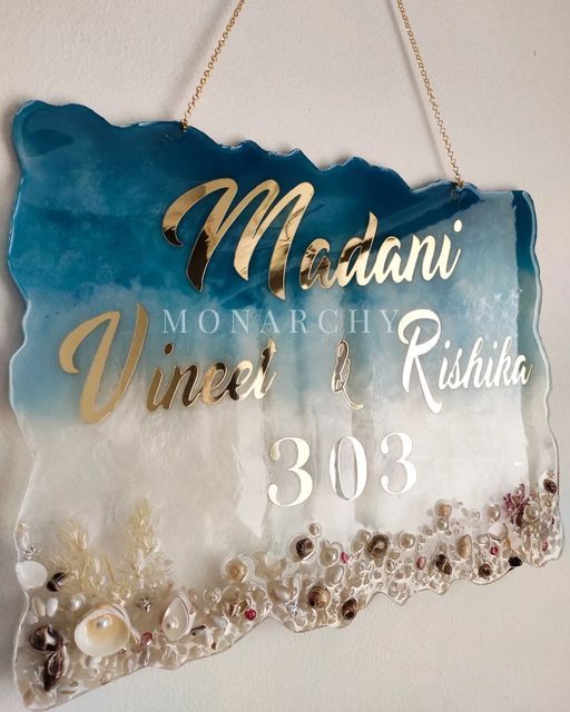 a sign hanging from the side of a wall with pearls and other things on it