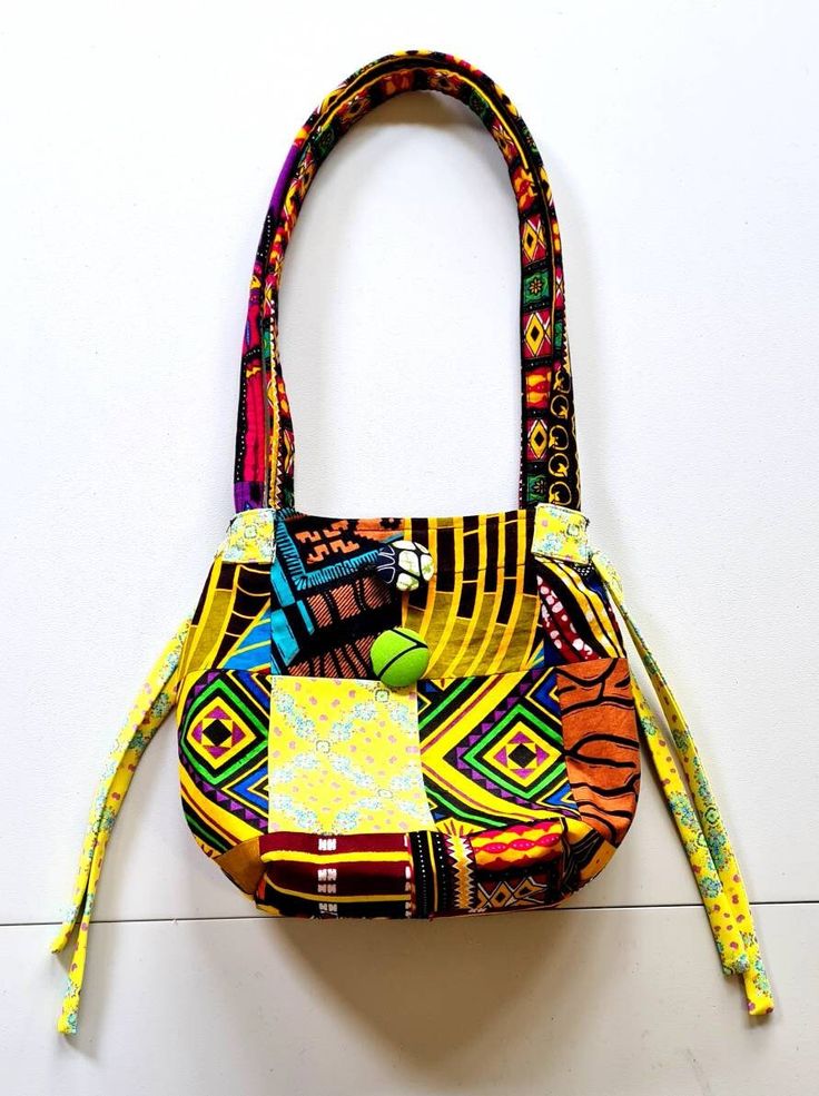 "This beautiful Patchwork Bag  is made from a combination of African printed fabrics. I saw this style of patchworking when I visited Gambia and couldn't resist using this technique to make a bag. Inside you will find a compartment to hold your phone, keys or change and closes with a button. Size = 8 5\" x 10\" Why not match it up with a pair of matching earrings? https://www.etsy.com/uk/ZemoraZemora/listing/1270815833/sunshine-earrings-summer-earrings-fabric?utm_source=Copy&utm_medium=ListingMa Multicolor Patchwork Satchel Shoulder Bag, Multicolor Rectangular Hobo Bag Gift, Multicolor Patchwork Tote Satchel, Colorful Patchwork Shoulder Bag For Daily Use, Multicolor Patchwork Tote Bag, Multicolor Patchwork Satchel Bag, Multicolor Bucket Bag With Removable Pouch, Multicolor Square Hobo Bag For Daily Use, Square Multicolor Hobo Bag For Daily Use