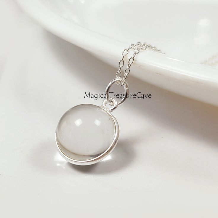 "Natural Clear Quartz Necklace, 925 Sterling Silver Jewelry, Quartz Ball Design Necklace, Minimalist Necklace, Bridesmaid Gift, Wedding Gift  : D E T A I L S : Handcrafted with lots of love ♥ and care Gemstone- Clear Quartz  Finish: Silver  Closure: Lobster clasp Measurement: Length: 17\" Extender: 2\" Pendant Size: Width: 13.2 mm, Length: 20 mm Our Jewelry is Gold polished on 925 sterling silver metal. This piece of jewelry is perfect as a gift for yourself, for a friend, a gift for Valentine's day, or a birthday. Magical Treasure Cave: Please check out the rest of our shop by clicking: https://www.etsy.com/in-en/shop/MagicalTreasureCave QUESTIONS: We are always happy to answer any of your questions, so please contact us via convo, we would love to hear from you! : C A R E : Please do not Delicate Silver Charm Necklaces For Bridesmaids, Minimalist Round White Jewelry, Minimalist White Round Jewelry, Delicate Silver Hypoallergenic Charm Necklace, Delicate Hypoallergenic Silver Charm Necklaces, Delicate Hypoallergenic Silver Charm Necklace, Sterling Silver Round Pendant Jewelry For Wedding, Sterling Silver Birthstone Necklaces For Weddings, Simple Sterling Silver Jewelry With Birthstone