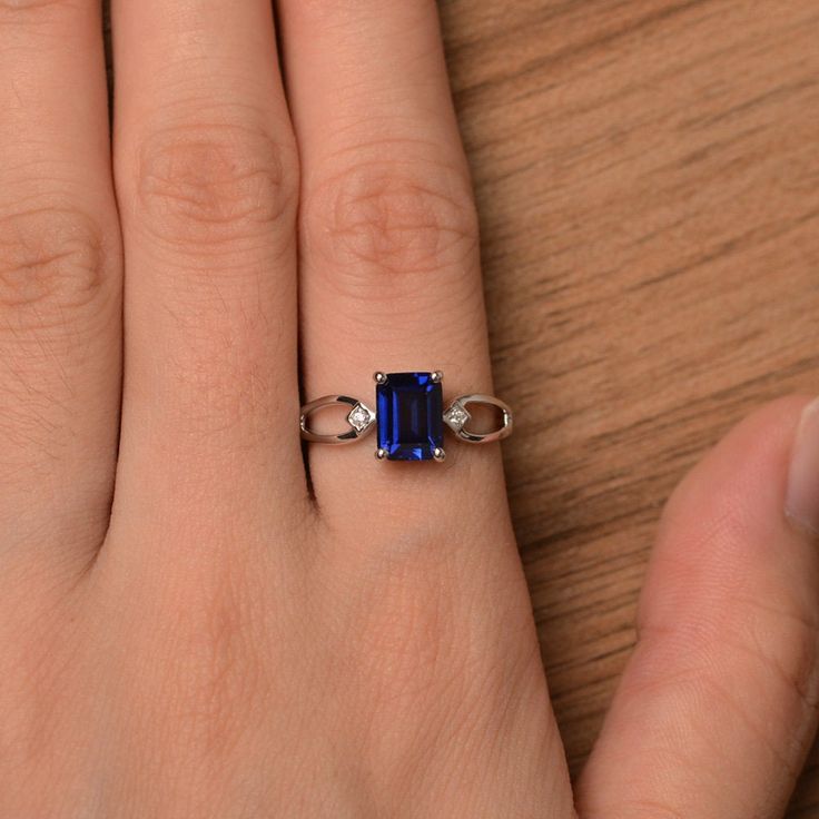 It is a lab sapphire ring. The main stone is 6 mm*8 mm emerald cut.weight about 1.7 carats. The basic metal is sterling silver and plated with rhodium. To change the metal to a solid gold (white/rose) or platinum is also available, please ask for a quotation if you want. You can also go to my shop Home for more elegant rings: https://www.etsy.com/shop/godjewelry?ref=hdr_shop_menu Sapphire is September birthstone More sapphire rings: https://www.etsy.com/shop/godjewelry?ref=seller-platform-mcnav& Blue Sapphire Ring In Emerald Cut Sterling Silver, Blue Emerald-cut Sapphire Ring In Sterling Silver, Emerald-cut Sapphire Birthstone Ring, Blue Sapphire Birthstone Ring With Emerald Cut, Blue Emerald Cut Ring For Birthstone, Blue Emerald Cut Ring, Birthstone, Blue Emerald-cut Ring With Birthstone, Blue Emerald Cut Ring With Birthstone, Sapphire Emerald-cut Birthstone Ring In Fine Jewelry Style