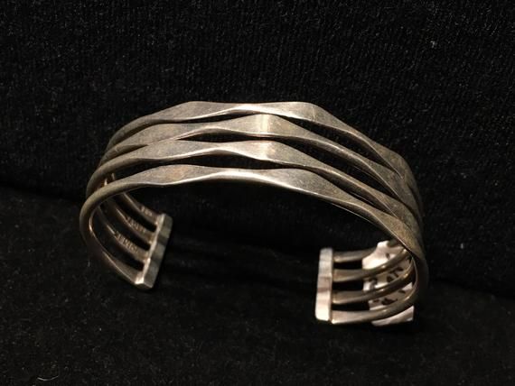 Old Mexican Sterling Silver abstract modern cuff bracelet with attractive MCM style sculptural positive space-negative space design.Mexico & 925 stamps, plus another one I can't make out, possibly the hallmark of the maker?.75" wide5 1/8" interior circumference plus 1 3/8" flexible gap25g507R***- This stunning piece is coming from an exciting relationship with a well known & popular Santa Fe, NM, jewelry gallery. I will be listing many exquisite pieces, some at lower prices than they are Modern Sterling Silver Bracelet, Modern Adjustable Cuff Bracelet, Modern Cuff Bangle Bracelet, Contemporary Sterling Silver Bangle Bracelet, Modern Sterling Silver Bangle, Contemporary Adjustable Sterling Silver Bracelet, Contemporary Formal Cuff Bracelet Bangle, Modern Adjustable Sterling Silver Bracelet, Adjustable Modern Sterling Silver Bracelet