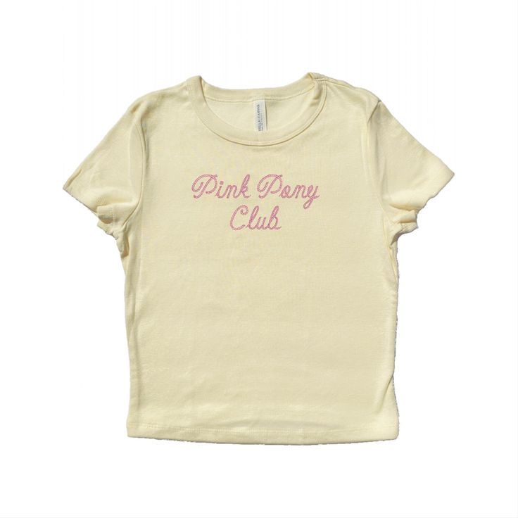 Baby tee with "Pink Pony Club" written in a cowboy rope font and embroidered in pink polyester thread.  The perfect gift for a fan! <3 Drop down menu will reflect the color options shown. Please refer to the size chart on the last slide for accurate measurements. Baby tee fabrication: 52% airlume combed and ring-spun cotton, 48% polyester 32 single, 5.4oz Want a different embroidery color? Message us! We have a large variety of colored thread to choose from. Cute Pink T-shirt With Letter Embroidery, Pink T-shirt With Embroidered Text For Summer, Pink Embroidered T-shirt For Summer, Pink Short Sleeve T-shirt With Embroidered Graphics, Pink Summer Top With Embroidered Text, Pink Tops With Embroidered Text For Summer, Pink Top With Embroidered Text For Summer, Unisex Pink T-shirt For Spring, Pink T-shirt For Spring