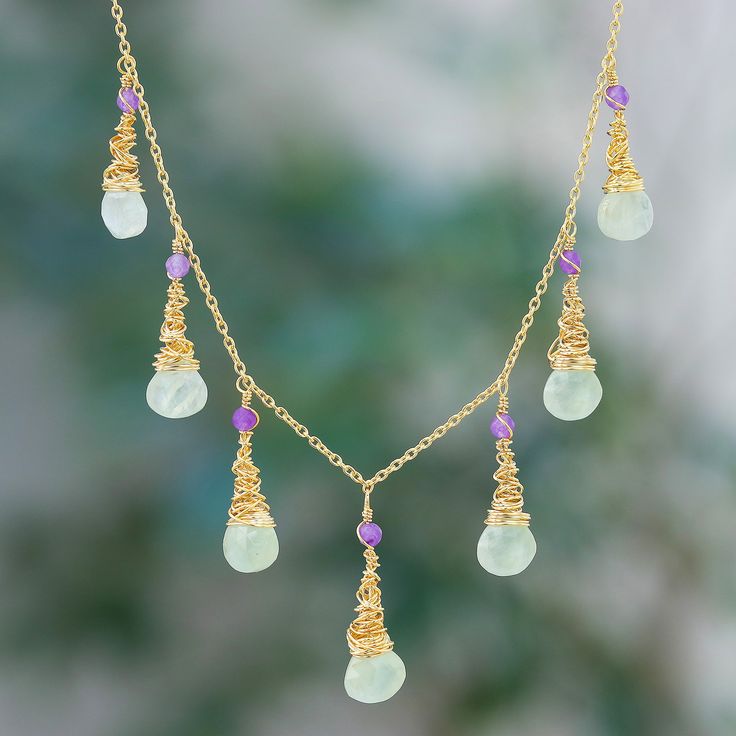 The magical aura of these jewels will make you dazzle with a unique light. Crafted in Thailand by Somsiri Juntamin, the accessory features 24k gold plating that creates a glamorous vibe around the prehnite and amethyst gemstones that dangle from the design. As a final touch, this waterfall necklace also comes in a polished finish for a lustrous look. Gold Chalcedony Jewelry As A Gift, Yellow Gold Chalcedony Gemstone Necklace, Spiritual Yellow Gold Necklaces With Gemstone Accents, Spiritual Yellow Gold Necklace With Gemstone Accents, Gold Amethyst Necklace For Healing, Gold Necklaces With Natural Stones And Chalcedony, Gold Necklaces With Natural Stones In Chalcedony, Gold Fusion Necklaces With Gemstone Accents, Gold Necklaces With Gemstone Accents For Healing