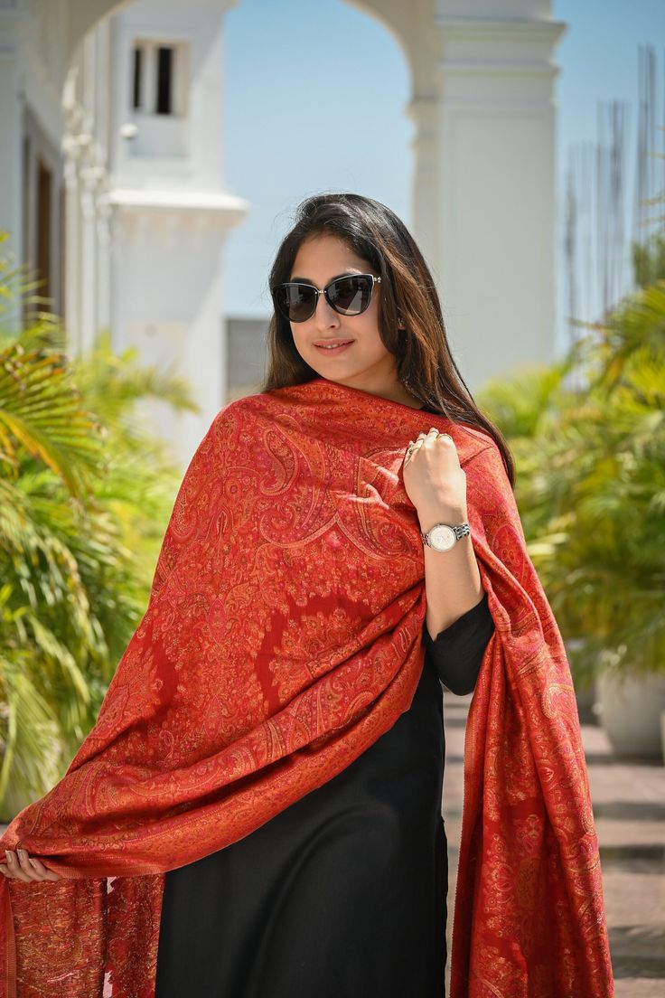 Red Kani Jamawar dupatta in silk fabric has been meticulously woven into rich & traditional floral motifs and vibrant colour palette to suit all eyes. This gorgeous and rich Kashmiri Pashmina Silk Dupatta is suitable for any celebration or gathering. Be it a wedding function or a festive celebration, it adds colour and vibrance to your outfit as you team it with salwar suit/ kurta set for an ethnic look or simply don with any modern outfit for that contemporary look. Colour: Red Craft: Kani Weave Fabric: Silk Dimensions:                 L - 2.45 m                 W - 0.95 m Red Jamawar Pashmina Shawl, Red Jamawar Shawl With Dupatta Detail, Red Jamawar Shawl Dupatta, Traditional Pashmina Shawl With Pallu, Traditional Red Jamawar Shawl, Pashmina Shawl With Pallu For Traditional Ceremonies, Traditional Red Pashmina Dupatta Shawl, Traditional Red Pashmina Shawl Dupatta, Red Bollywood Jamawar Pashmina Shawl