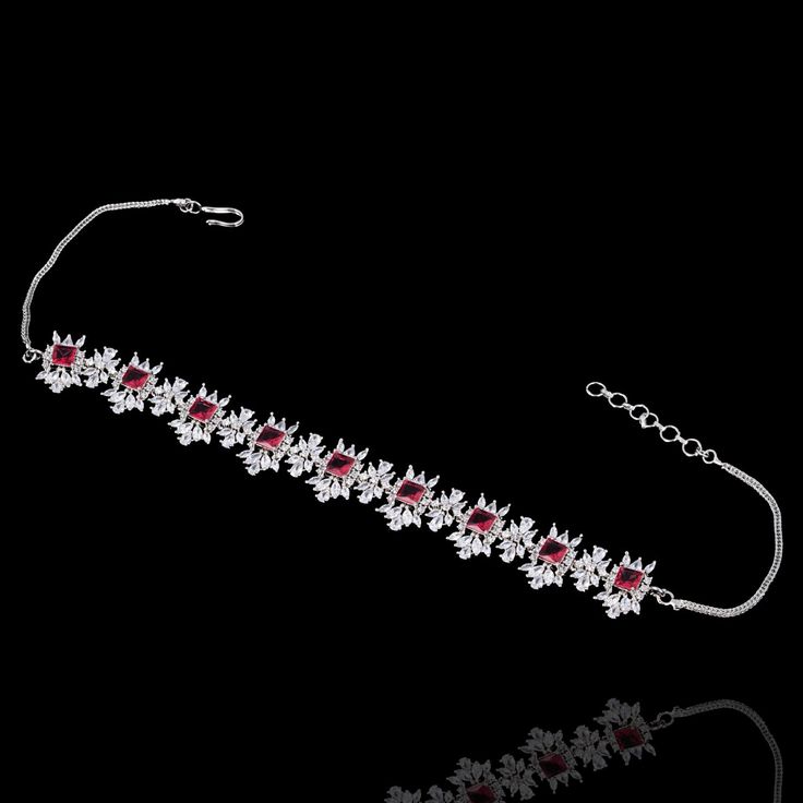 For edgy style and sophisticated sparkle, this necklace set is a dream come true! Elegant and shimmering set with CZ and ruby stones creating a flawlessly fresh finish for each and every one of your evening ensembles. The set includes a choker paired with a necklace, a matching teekah and a pair of beautiful earrings. Approximate earrings length is 2.1". Please click on the video for a detailed view of the product. Designed over a high-quality brass as base metal. Available in 3 plating options. Ruby Necklaces With Sparkling Stones For Party, Party Ruby Necklaces With Sparkling Stones, Party Ruby Necklace With Sparkling Stones, Elegant Ruby Choker As A Gift, Elegant Red Choker Jewelry Sets, Elegant Red Choker For Formal Occasions, Unique Gift Cards, Edgy Style, Create Words