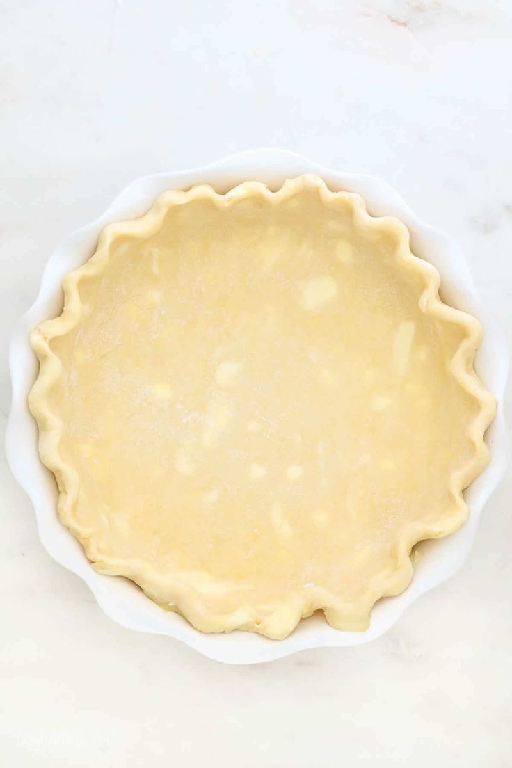 an uncooked pie crust in a white bowl