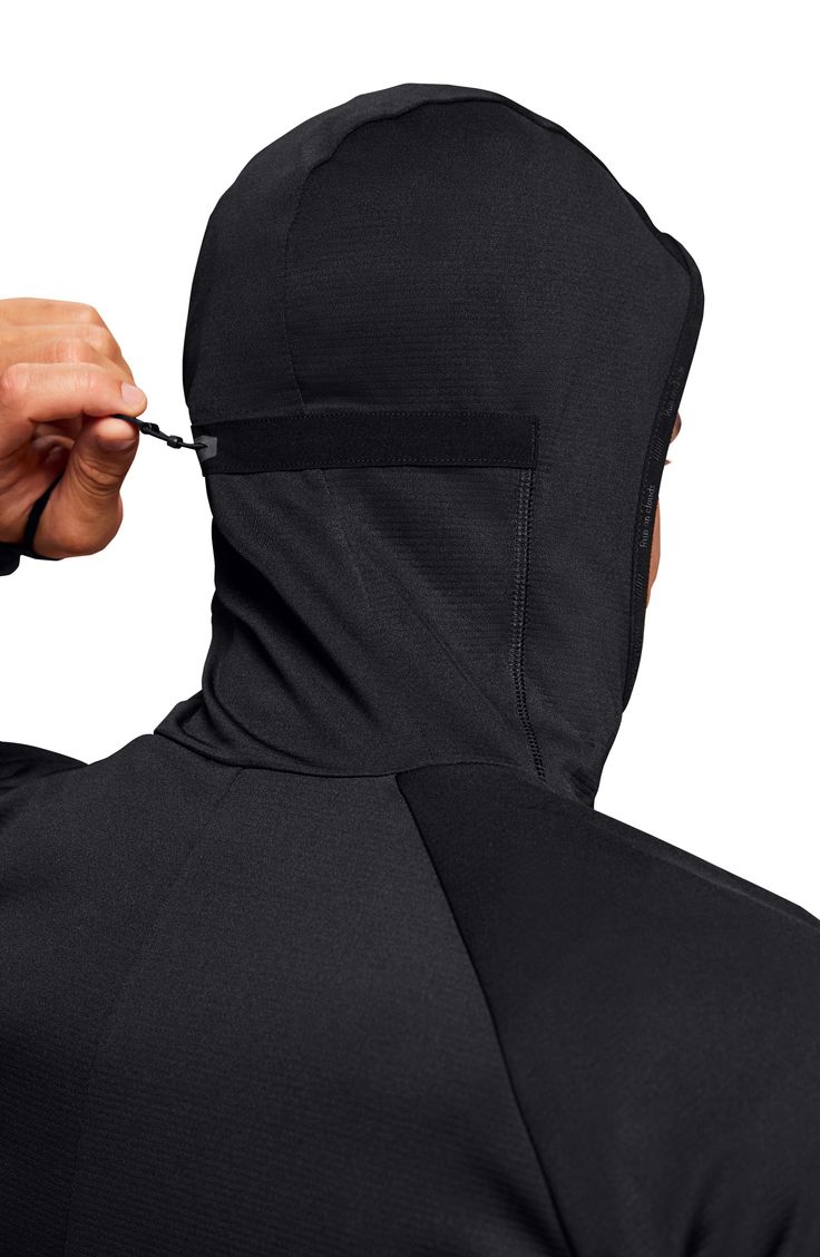 Fast-drying fabric keeps up with you for miles in a running top designed with a back hood adjustment with a built-in mask to keep your face warm. 27 1/2" length (size Medium) Front zip closure Drawcord-toggle hood with built-in face mask Thumbhole cuffs Side zip pocket Spiral darts elbow and contoured back seam Reflective details enhance visibility in low light or at night 100% recycled polyester Machine wash, dry flat Imported Running Hoodie, On Running, Running Tops, Low Light, Zip Sweater, Thumb Holes, Black Hoodie, Black Noir, Zip Hoodie