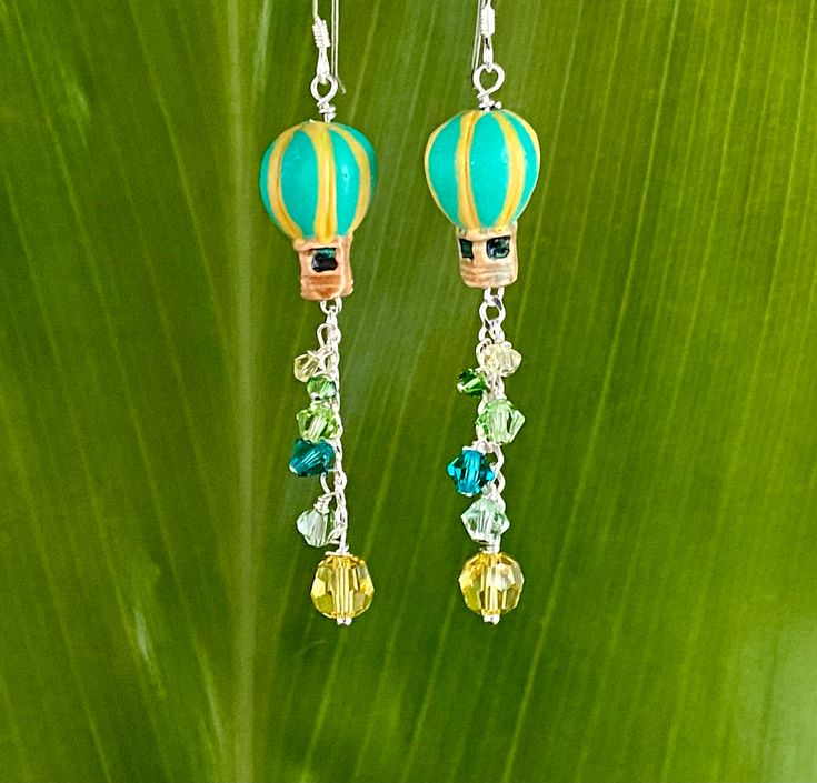 Fully glazed and decorated Peruvian ceramic aqua and yellow Hot Air Balloon beads trail vibrant authentic Swarovski Crystals on Sterling chain. Hang 2 inches below Sterling hooks. Free Shipping, Gift box included. Fun Jewelry With Dangling Beads For Gift, Fun Dangling Beads Jewelry As Gift, Fun Dangling Beads Jewelry For Gifts, Turquoise Jewelry Gift, Fun Yellow Nickel-free Jewelry, Handmade Green Jewelry With A Fun Style, Handmade Fun Green Jewelry, Handmade Green Fun Jewelry, Fun Yellow Round Beads Jewelry