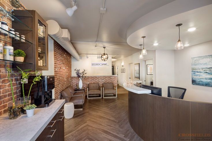 the interior of a hair salon with wooden floors and brick walls, along with modern furnishings