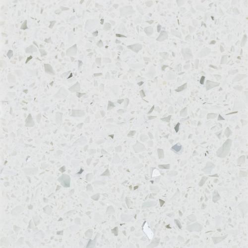 a white marble counter top with lots of small pieces of glass on the bottom and sides