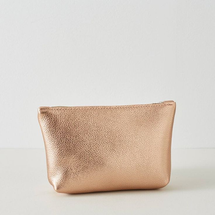 Introducing our stylish Rose Gold Leather Cosmetic Pouch, the perfect travel bag and make-up bag for any woman on the go. This luxurious pouch is made from high-quality, soft leather and features a secure zipper closure to keep all of your essential items safe and organised. Not only is this cosmetic pouch practical, but it also makes for an ideal gift for her, particularly as a bridesmaid gift idea. The soft rose gold leather adds a touch of sophistication to any outfit, making it a versatile a Chic Bags With Interior Card Slots As Gift, Chic Rectangular Cosmetic Bag For Gifts, Chic Gold Coin Purse For Travel, Chic Rectangular Cosmetic Bag As Gift, Blush Clutch Bag For Everyday Use, Blush Clutch Bag For Travel, Chic Cosmetic Bag With Zipper Closure As Gift, Chic Compact Travel Bags, Chic Coin Purse With Card Slots For Travel