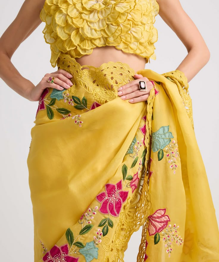 Drape yourself in elegance with this yellow silk organza sari, adorned with intricate floral applique, delicate threadwork, captivating beadwork, and exquisite cutwork. This ensemble embodies sophistication and charm, perfect for making a memorable statement at any special occasion. Organza Sari, Indian Dress Up, Indian Kurti Designs, Traditional Blouse Designs, Fancy Sarees Party Wear, Saree Designs Party Wear, Designer Sarees Online, Yellow Silk, Pakistani Bridal Dresses