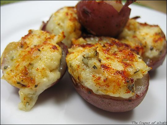 potatoes with cheese and herbs on a white plate