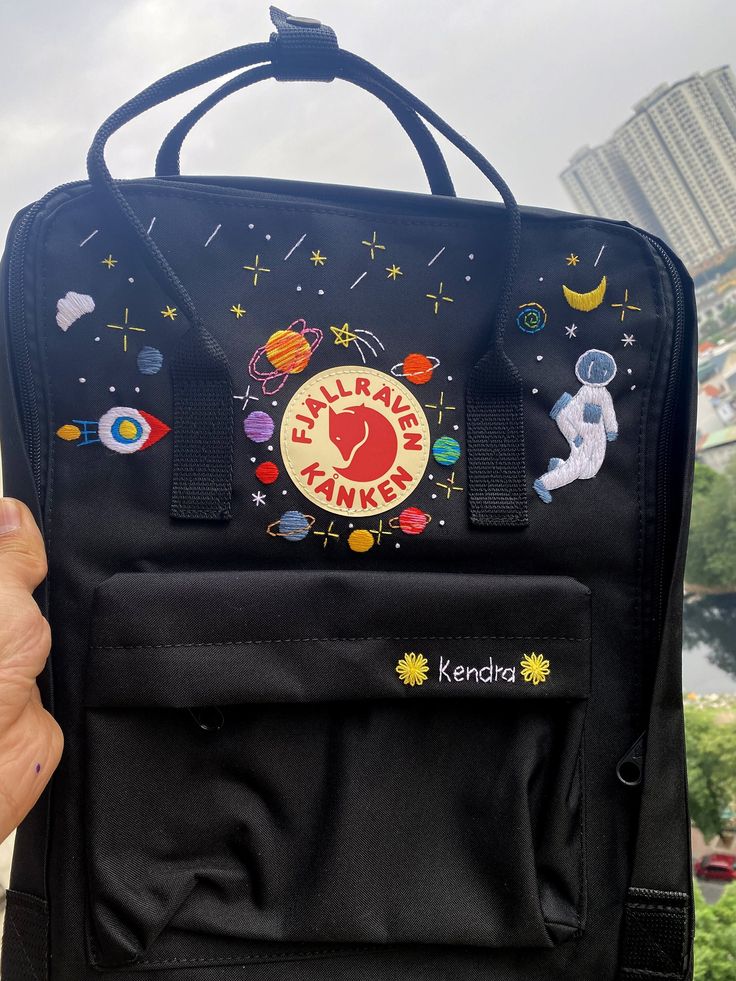 Welcome to our charming collection of hand-embroidered Fjallraven Kanken backpacks, meticulously crafted with love and precision. Elevate your style and stay organized on-the-go with these premium quality backpacks available in two convenient sizes:  - Medium (27x38x13cm)  - Large (32x42x13cm) + Key Features: - Hand-Embroidered Excellence: Each Fjallraven Kanken backpack is adorned with exquisite hand-embroidery, creating a unique and exclusive piece that sets you apart from the crowd. - Premium Embroidered Kanken, Astronaut Backpack, Kanken Embroidery, Kanken Bag, Backpack Embroidery, Planets In The Solar System, Medieval Party, Embroidery Bags, Backpack Charm