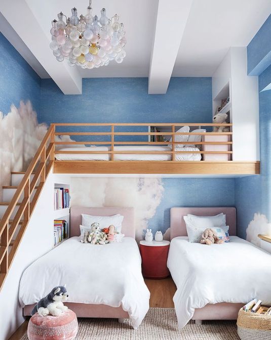 two twin beds in a room with blue walls and white carpeted flooring on the bottom level