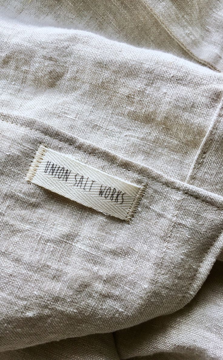 a label on the back of a white shirt that says, way out words written in black ink