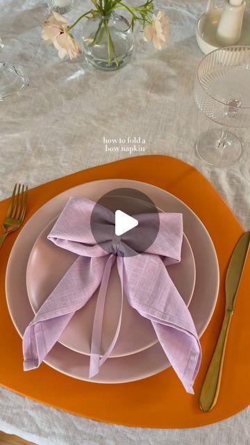 an orange plate with a purple bow on it