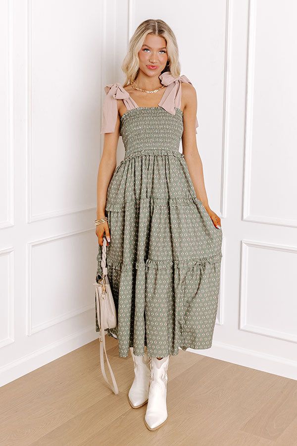 - Twirl into a perfect day with this charming midi dress! Its delightful floral print and smocked bodice bring a touch of sweetness, while the tied straps add a darling detail. Effortless style and carefree moments await! - Unlined material with appetite floral print featuring ivory, green, and pink hues - A square cut neckline with ruffle detailing - Tied straps - A smocked bodice - An elastic waistline - Ruffle detailing - A flowy yet flattering silhouette that ends in a straight midi length h Dressy Dress, Suede Boots Knee High, Dressy Dresses, Willow Tree, A Perfect Day, Green And Pink, Square Cut, Perfect Day, Midi Length