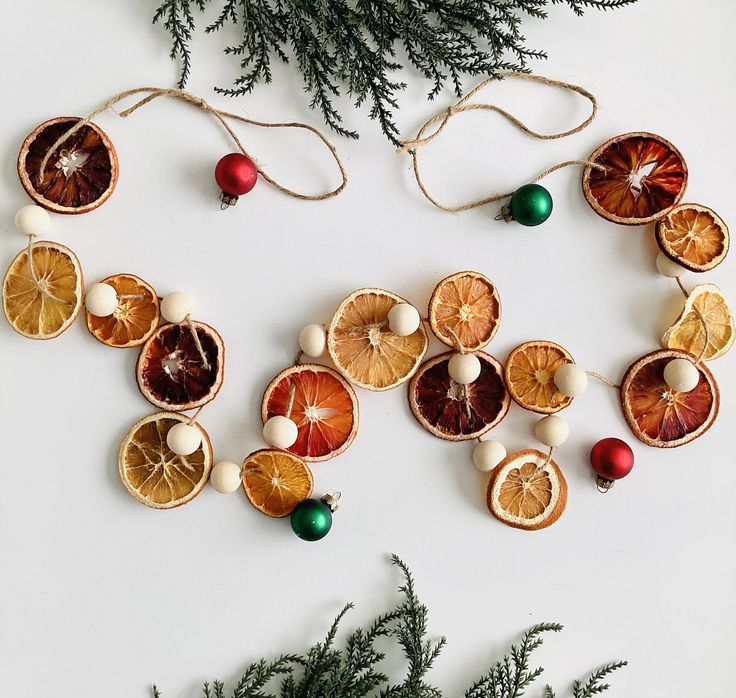 "<< Are you looking for a natural garland for your Christmas decor? Then this dried orange slice garland with beads is the perfect touch to your holiday decorating. They add a fragrant scent of citrus to your home. Give your mantle, fireplace or tree a little whimsy this year.  << This garland has a mixture of 3 oranges. Mandarin, Navel and Blood oranges.  A total of 16 oranges and 15 beads on a 6' jute string.  << Please note that blood oranges are seasonal and only available from November through March. A pink/red grapefruit will be substituted in its place during off season. << The loops are adjustable so you can shorten the string if need be. Please note that items can shift on the string, just space accordingly to your liking.  << Approximate Measurements: << 6' jute string with end l Orange Slice Garland, Natural Garland, Eco Friendly Christmas Decorations, Zero Waste Christmas, Mantle Fireplace, Festive Activities, Sustainable Christmas, Eco Friendly Christmas, Orange Christmas