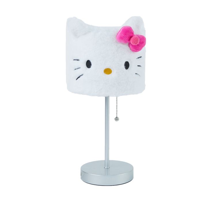 a white hello kitty lamp with a pink bow on it's head and eyes