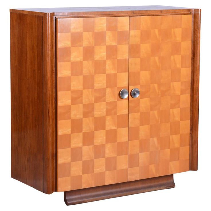 a wooden cabinet with two doors on the front and one door open to reveal a checkerboard pattern