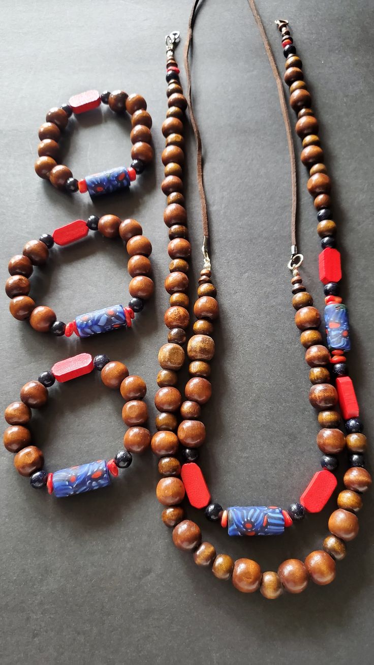 3 bracelets  1 corded necklace  1 beaded necklace Blue Sandstone beads Blue and red African Glass Beads Wood beads 5pc set $98 Cord Necklace & 1 bracelet $40 Beaded Necklace & 1 bracelet $48 Everyday Red Jewelry With Colorful Beads, Multi-strand Beaded Bracelets With Large Beads As Gift, Adjustable Multi-strand Wooden Bead Jewelry, Gift Multi-strand Beaded Bracelets With Large Beads, Red Round Beads Jewelry For Everyday, Red Round Beaded Jewelry For Everyday, Everyday Red Round Bead Jewelry, Adjustable Wooden Oval Beads Jewelry, Oval Wooden Beads Jewelry Gift