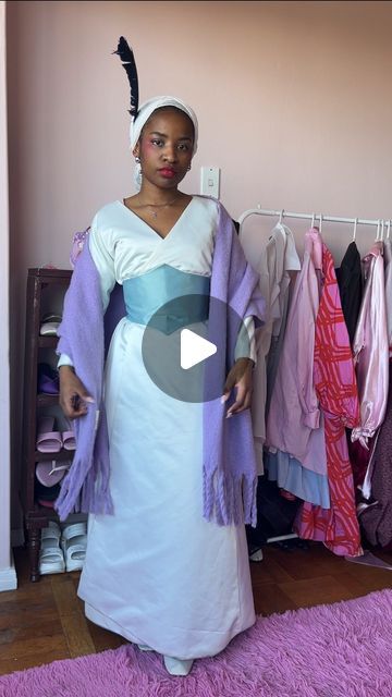 a woman standing in front of a closet full of clothes