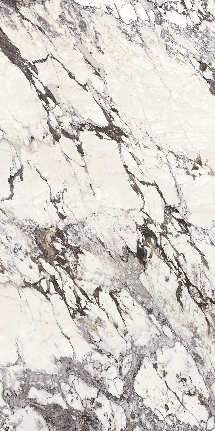 a white and brown marble counter top with black veining on the edges, in an angled view