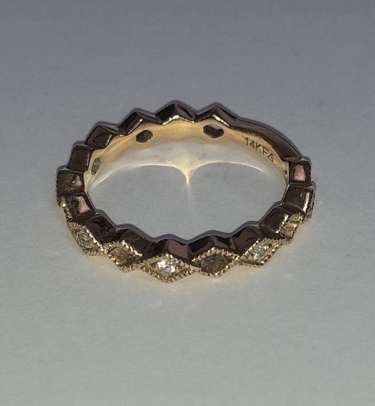 Beautifully vintage. Solid 14K Yellow Gold Diamond Ring. Eternity Band. Beaded detail Marquise design with natural, round cut Diamonds. Sizing bar in back. Stamped 14K and designer's hallmark. Great alone or stacked. Ring size approximately 5.25 - 5.5. Vintage 14k Gold Stackable Jewelry, Classic Stackable Jewelry For Anniversary, Heirloom Diamond Ring With Decorative Band, Round Cut, Heirloom Round Cut Diamond Ring With Decorative Band, Diamond Eternity Band With Decorative Details For Anniversary, Anniversary Diamond Eternity Band With Decorative Details, Stackable Marquise Yellow Gold Jewelry, Classic Diamond Ring With Decorative Band, Classic Round Diamond Ring With Decorative Band