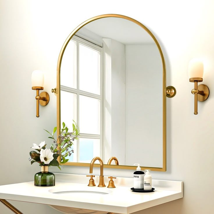 a bathroom sink with a mirror above it and a vase on the counter next to it