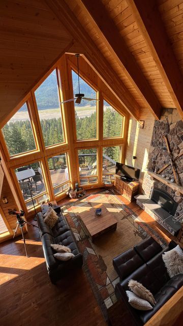 an aerial view of a living room with high ceilings and large windows on the wall