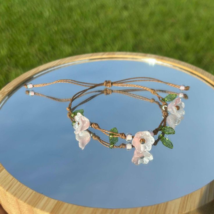 This is an adjustable string bracelet with a pink flower charm.  exactly like these pictures. feel free to ask me for any questions. thank you <3 Adjustable String Bracelet, Rose Bracelet, Floral Bracelet, Glass Flowers, String Bracelet, Flower Charm, Pink Glass, Pink Flower, Arm Band