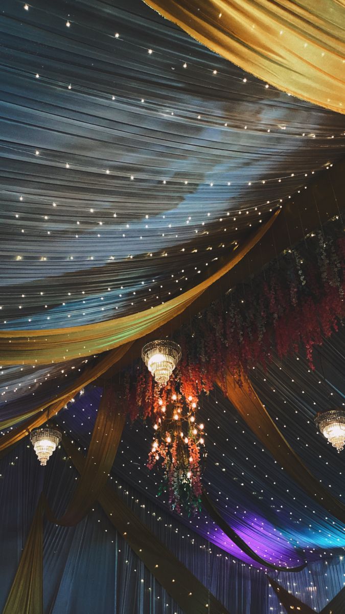 the ceiling is decorated with lights and draping