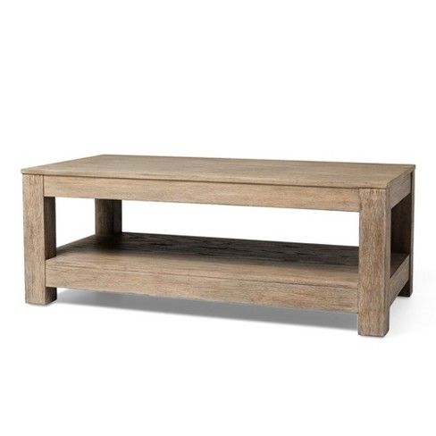 a wooden coffee table sitting on top of a white floor