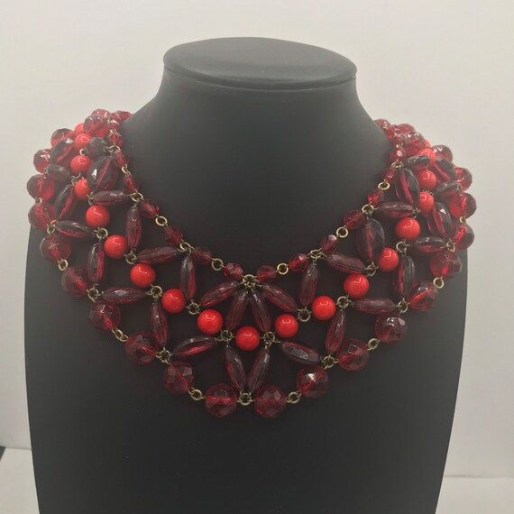 264.00 USD Red glass and Lucite bib beaded statement choker necklace in very good vintage condition. Measures 14 1/2 inches long and has red rhinestones on the clasp. Very pretty unique mid century piece. Perfect for any little black dress or nice outfit. Vintage Red Choker For Party, Vintage Red Choker Jewelry, Vintage Red Choker Necklace, Red Vintage Choker Jewelry, Red Vintage Choker Necklace, Red Beaded Choker For Party, Retro Red Necklace For Party, Handmade Red Vintage Choker, Handmade Red Necklace For Evening