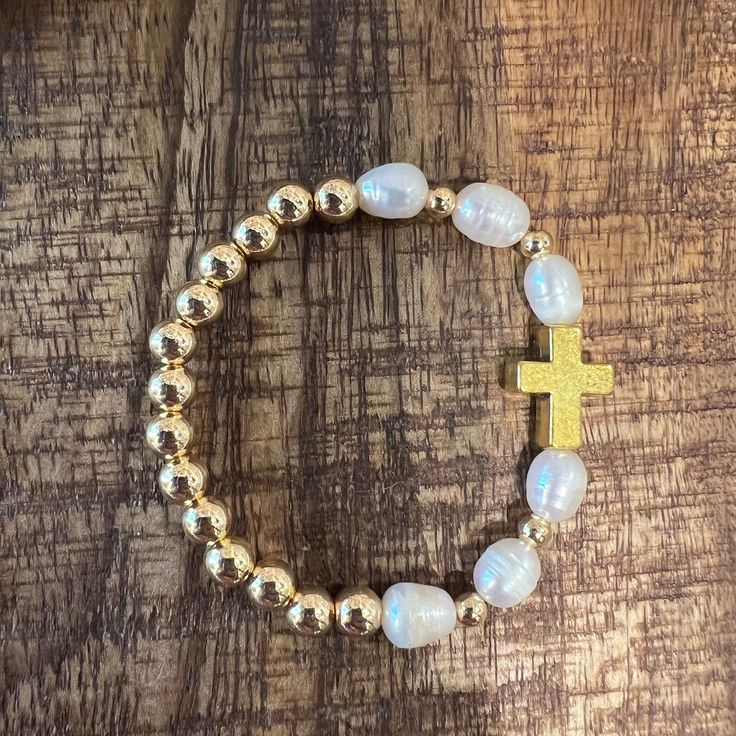 Pearl and gold bead bracelet with Gold cross charm Spiritual Gold Jewelry With Pearl Charm, Gold Cross-shaped Beaded Bracelets For Gifts, Gold Cross Beaded Bracelets For Gift, Gold Beaded Cross Bracelets For Spiritual Style, Gold Cross-shaped Spiritual Beaded Bracelets, Gold Cross Beaded Bracelets For Spiritual Style, Gold Spiritual Beaded Cross Bracelets, Gold Rosary Bracelet With Cross And 8mm Beads, Spiritual Gold Beaded Cross Bracelets