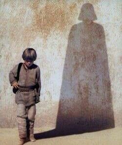 a young boy standing in front of a shadow