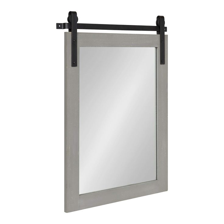 a mirror that is hanging on the wall with a black frame and metal bar around it