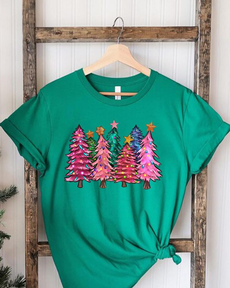 Woman's Holiday Tshirt, Women's Xmas Tee, Christmas Tree Tee, Xmas Tree, Women's Christmas Tshirt, Winter Tee, Merry and Bright Trees, Xmas 📢Please Check All Photos For Details.   📢Choose Your T-Shirt Size From The Drop-Down Lists Next To The item Picture   📢Choose Of Your T-Shirt Color From The 2nd Picture 🧨Please contact the store for long-sleeved shirt and sweatshirt color options. 🧨Please check which product you are paying for in the size options section, because there are different opt Multicolor Crew Neck Christmas Top, Multicolor Crew Neck T-shirt For Winter, Christmas Cotton T-shirt, Christmas Graphic Print Short Sleeve Tops, Green Christmas Crew Neck T-shirt, Green Christmas T-shirt For Holiday, Festive Winter T-shirt With Short Sleeves, Festive Short Sleeve T-shirt For Winter, Green T-shirt For Christmas Holiday