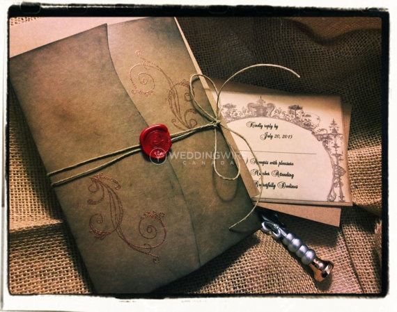 an old envelope with a wax stamp on it and a red wax seal attached to it