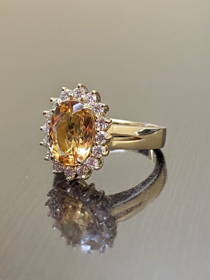 a fancy yellow diamond ring on a reflective surface