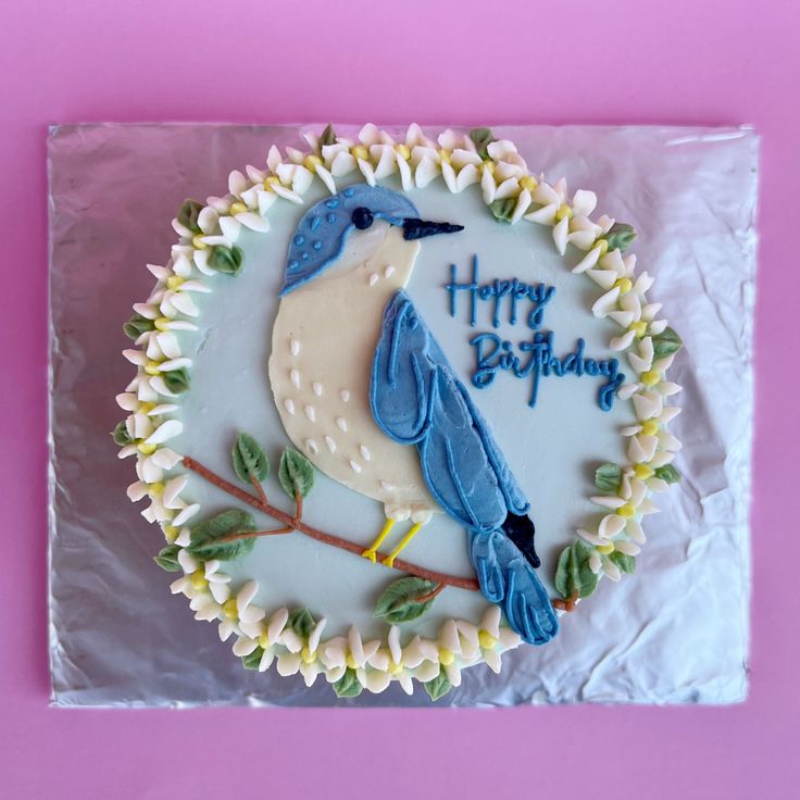 a birthday cake with a blue bird on it