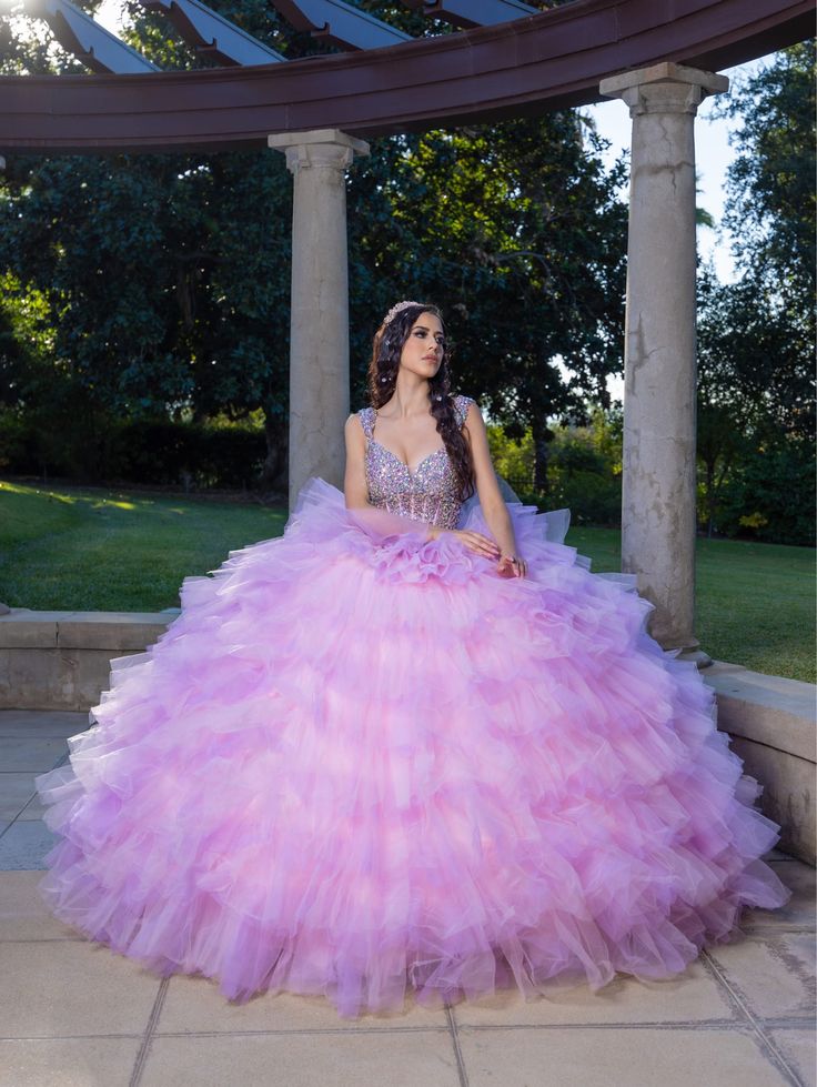 Make a grand entrance in this beaded long sleeveless corset dress with an A-line ruffled tiered skirt from LizLuo Quince by the House of Wu 26095. This quinceañera gown is fit for a princess with its sparkling diamond-like appearance. The corseted bodice features bold and beautiful statement beads, while the exposed boning detail adds a modern touch. The grand and spectacular multi-tiered ruffle skirt is available in two color options: Aqua Multi and Pink Multi. House of Wu LizLuo Quince Collect Elegant Tulle Quinceanera Dress With Ruffles, Elegant Quinceanera Dress With Ruffles In Tulle, Glamorous Gown With Ruffles And Fitted Bodice, Princess Quinceanera Dress With Ruffles, Princess Quinceanera Dress With Ruffles For Sweet 16, Princess Style Quinceanera Dress With Ruffles For Sweet 16, Glamorous Ball Gown With Ruffles And Fitted Bodice, Sweet 16 Ball Gown With Ruffles And Fitted Bodice, Sleeveless Ruffled Ball Gown For Quinceanera