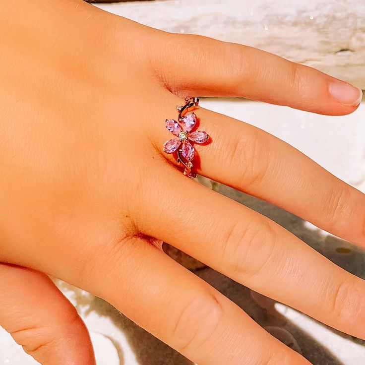 This gorgeous dainty sparkling pink topaz flower ring is perfect for everyday wear or for a special occasion. Makes the perfect gift for any occasion. * 18K Rose Gold Filled * Flower size is approximately 1x1cm * Simulated Topaz * Nickle and Lead Free *Size 6 and 7 only * Photos enlarged to show detail * Ring box included *For returns/refunds please contact me within 3 days, please ship items back in original condition within 7 days of receipt. Anniversary Pink Flower Shaped Ring, Pink Flower-shaped Rings For Anniversary, Pink Flower Rings For Anniversary, Adjustable Pink Flower Ring For Wedding, Rose Gold Flower Ring For Gift, Delicate Pink Flower Ring For Wedding, Elegant Adjustable Pink Flower Ring, Dainty Pink Flower Promise Ring, Pink Flower Promise Ring