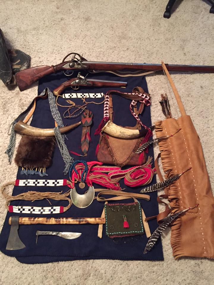 an assortment of hunting items laid out on the floor