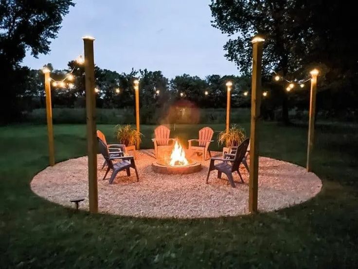 a fire pit surrounded by chairs and lights