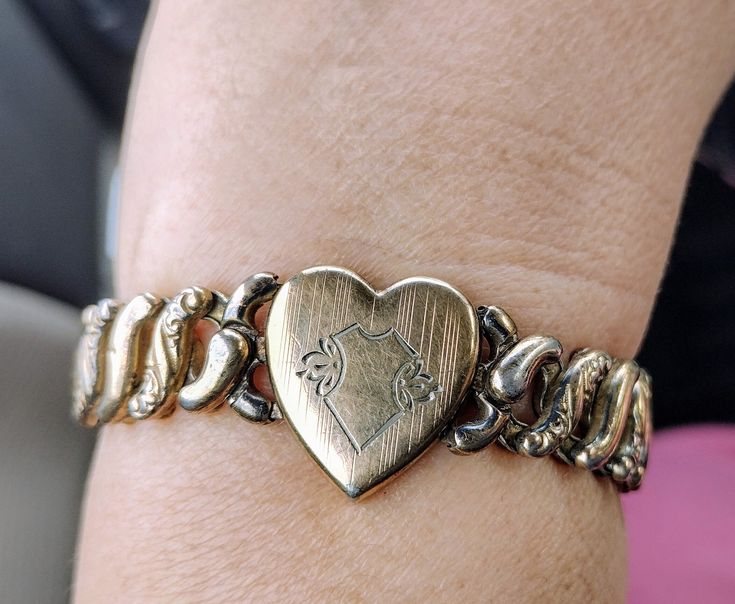 "Valentine's day! 💌 Antique sweetheart gold filled expansion bracelet Circa 1940s Marked:  'American Queen Pitman keeler Sterling base' This timeless beauty has remained unengraved and is ready to engrave if you so desire! 💗 Excellent condition,  darkened vintage patina.  light scratching on the surface of heart Please see pictures.  A majority of these jewelry pieces were produced in the 1930s & Forties. Gold Filled ( Not plated ) , they were given to a sweetheart by an American Soldier prepa Vintage Gold Bracelets For Valentine's Day, Vintage Heart Bracelet For Valentine's Day Anniversary, Vintage Gold Charm Bracelet For Anniversary, Vintage Gold Charm Bracelet For Valentine's Day, Vintage Gold Heart Bracelet As Gift, Vintage Gold Heart Bracelet For Anniversary, Vintage Gold Heart Bracelet For Gift, Gold Vintage Charm Bracelet For Anniversary, Vintage Heart Bracelet For Valentine's Day