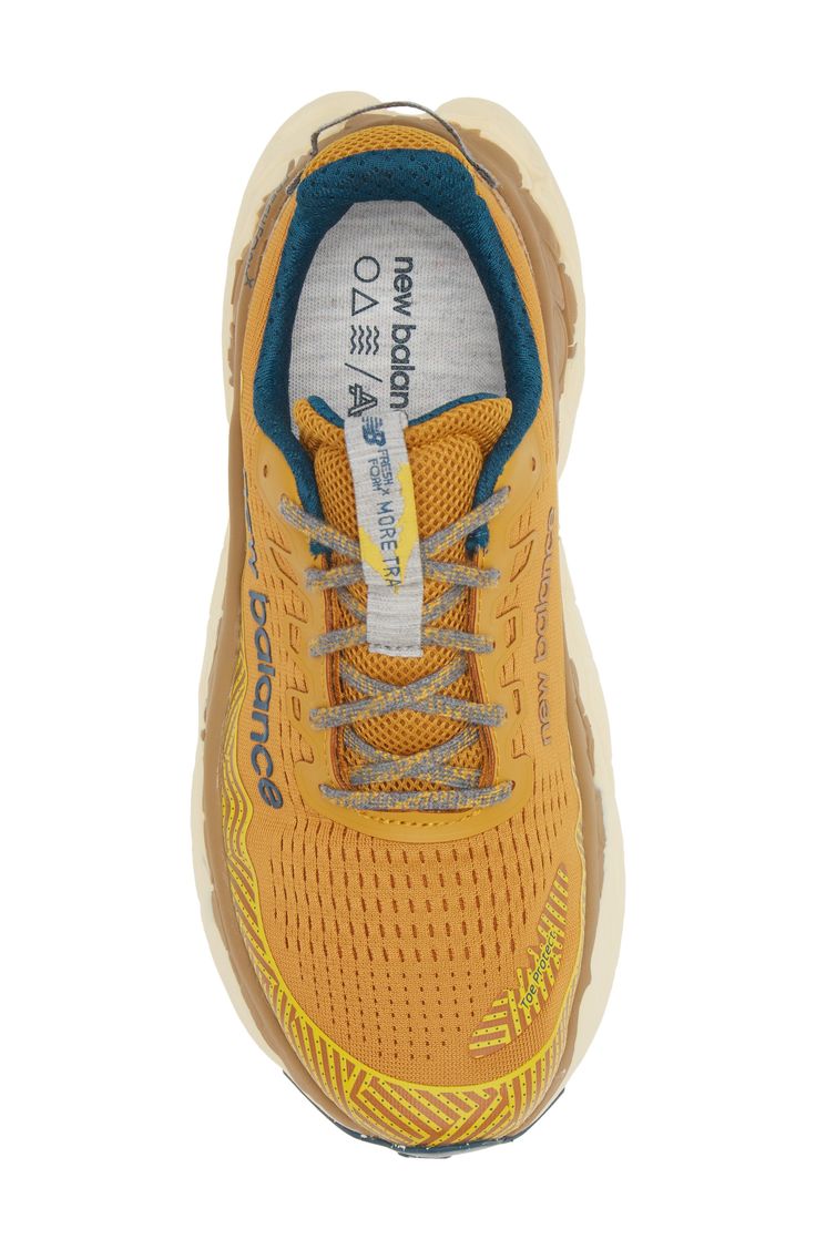 a yellow shoe with blue laces on the top and bottom part of the shoe