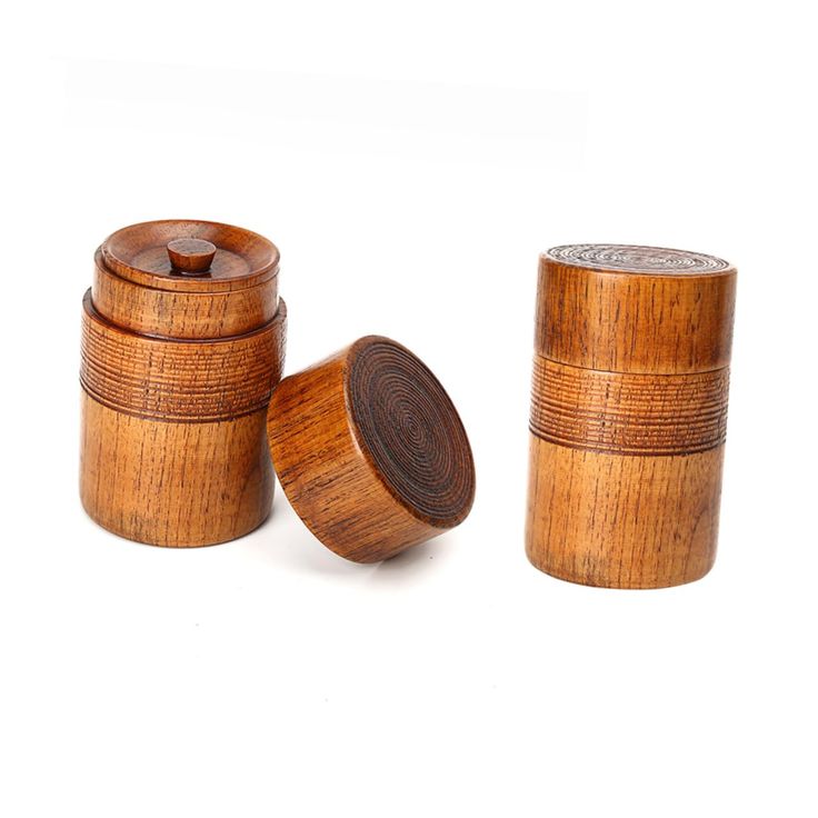 three wooden containers with lids on white background