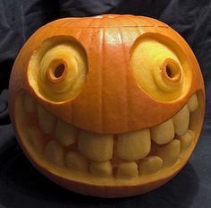 a carved pumpkin with large eyes and teeth